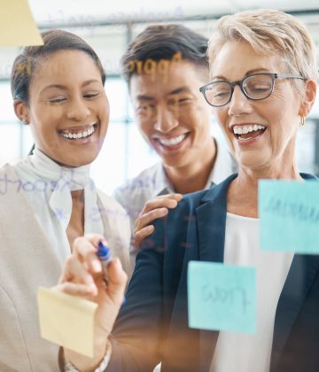 Teamwork, planning and strategy with a business woman, manager or CEO working with a team on a glas